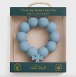 Blue silicone rosary shaped baby teether in retail packaging