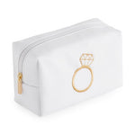 White rectangular cosmetic pouch with gold embroidered engagement ring design and gold zipper pull