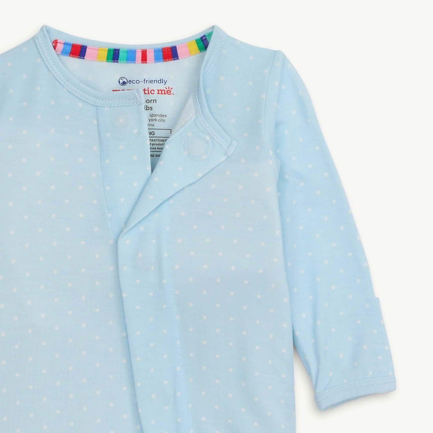 Light blue baby onesie with white polka dots and multicolored striped neck trim