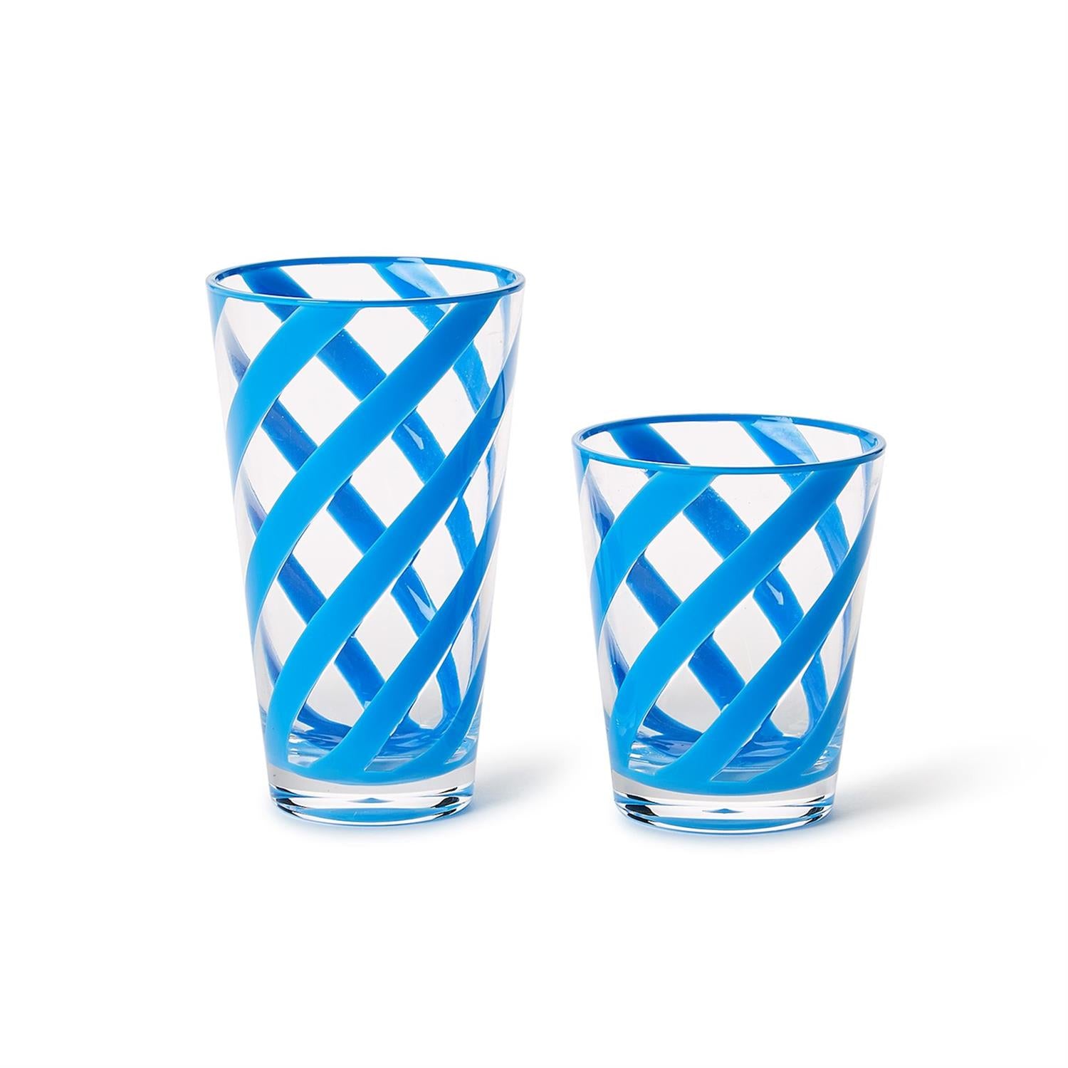 Hand-blown Murano glass drinking vessels are positioned on a white background, highlighting vibrant turquoise blue diagonal swirls and a unique crisscross latticework pattern across the clear transparent glass