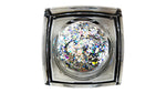Digital photography of a clear square cosmetic pot holding a round insert of iridescent chunky silver and multicolored glitter flakes on a white background, displaying a dazzling array of particle sizes