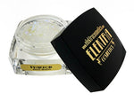 Product photo by Elektra Cosmetics showing an open clear jar of Phantom Bolt Balm iridescent white chunky glitter next to its black lid with a gold logo