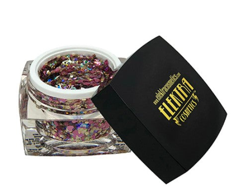 Digital photography by Elektracosmetics of an open clear jar filled with chunky iridescent cosmetic glitter shimmering in purple pink gold and blue-green hues, its black lid featuring the golden Elektracosmetics logo and lightning bolt symbol resting beside it on a white background
