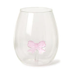 Clear stemless wine glass featuring a pink bow figure embedded at its base
