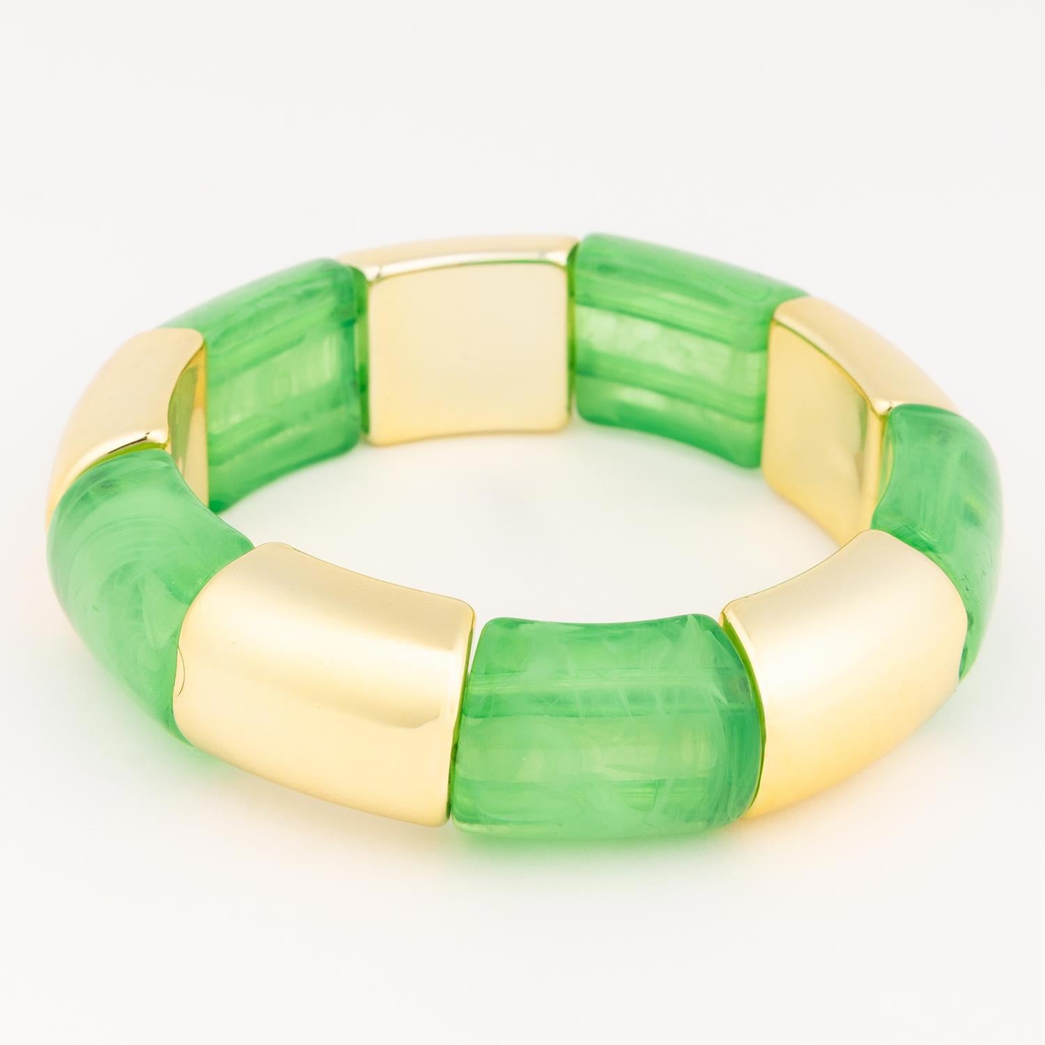 Jewelry bracelet featuring chunky alternating marbled green resin and shiny gold-toned metal segments presented on a plain white background