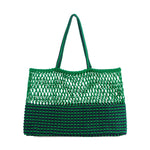 A bright green and navy blue knitted tote bag with an open mesh upper and a striped solid lower body featuring braided two-tone handles