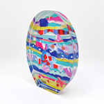 Acrylic and paper collage sculpture by J Dunn featuring a vibrant abstract oval faceted form filled with layered torn paper in electric blue, fuchsia, yellow, and red
