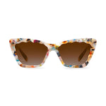 Product photo of cat-eye sunglasses on a white background featuring a multicolor terrazzo-like acetate frame, scalloped top edge, and brown gradient lenses