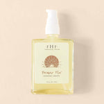 Photography of Farmhouse Fresh Bronze Fox Tanning Drops, a clear rectangular bottle with white pump dispenser containing light yellow liquid and a label featuring a rising sun graphic, set against a creamy beige studio background