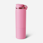 Product photo by BrüMate of a bubblegum pink matte insulated water bottle with a flip-top lid featuring a clear section and silver button, and the BrüMate logo vertically embossed near the base on a white studio background