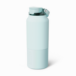 Product image of a BRUMATE pale aqua insulated water bottle featuring a translucent flip-top lid with a carry handle and an embossed BRUMATE logo on its distinctive lower removable cup