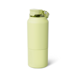 BRUMATE pale lime green insulated hydrator bottle featuring a matte finish, a transparent green flip-top lid, and the brand name vertically embossed on the lower body