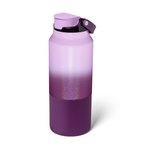 Product photograph by BRÜMATE depicting an insulated water bottle with a glittering light to dark purple ombre finish, a matte dark purple base displaying the BRÜMATE logo, and a purple flip-top lid with a carry handle