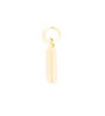 A small gold cylindrical bar charm with a polished finish attached to a circular jump ring on a white background