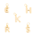 A collection of shiny gold-tone metal letter charms in a puffy bubble-font style, featuring letters E, H, K, R, and S, each with a small jump ring loop for attachment