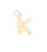 Gold initial K pendant with a smooth reflective surface and integrated bail
