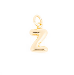 Gold jewelry puffed initial Z charm with a shiny yellow finish and open jump ring attached