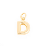 Gold charm featuring a shiny three-dimensional uppercase letter D with an attached jump ring
