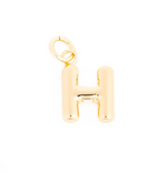 Gold bubble letter H charm with a polished finish and a small top loop isolated on a white background