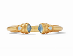 Gold cuff bracelet with blue faceted gemstones