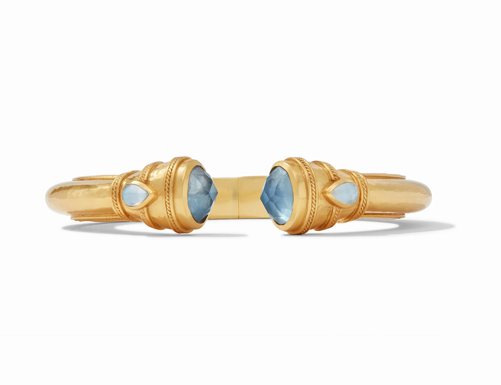 Gold cuff bracelet with blue faceted gemstones