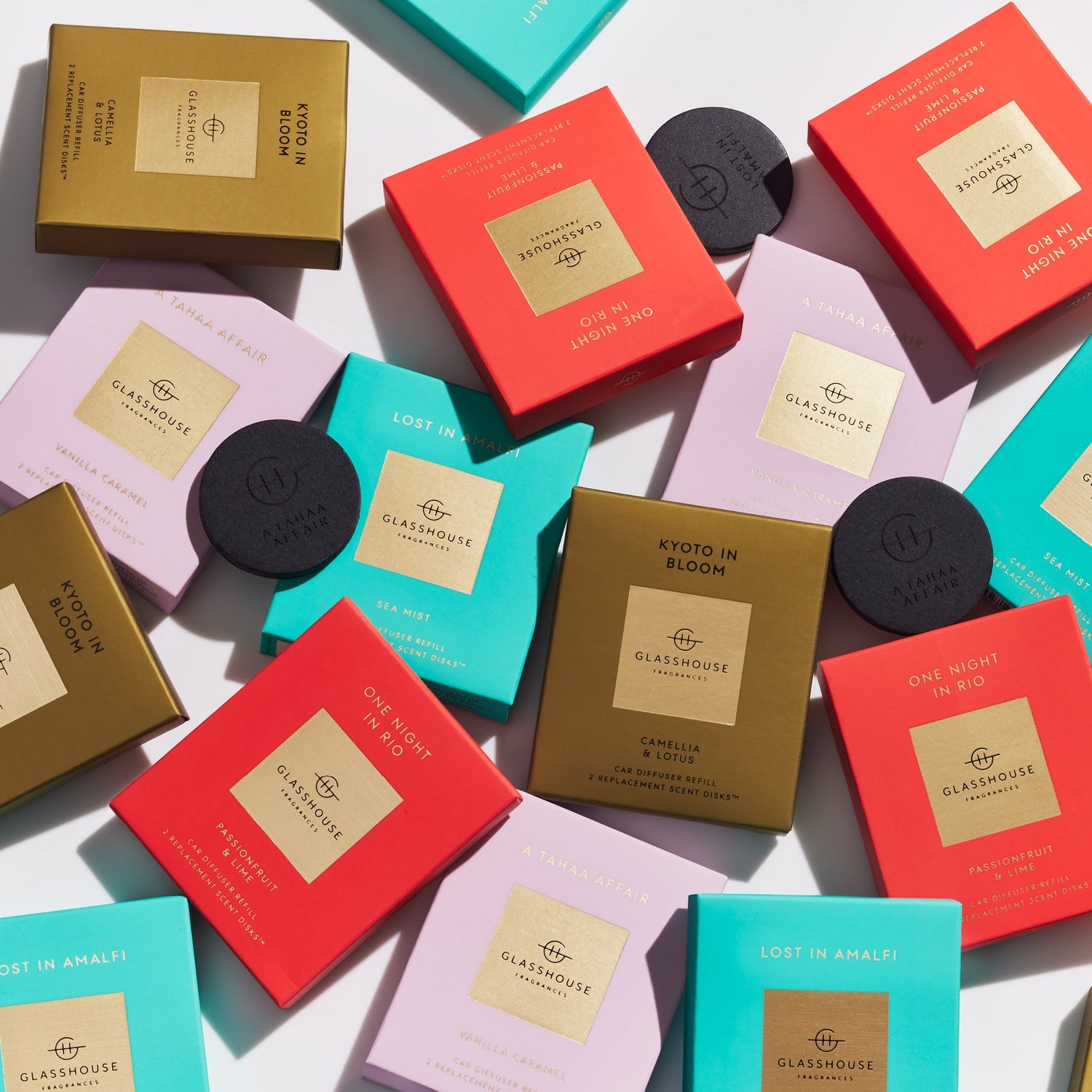 Assorted Glasshouse Fragrances car diffuser refill boxes and scent disks in various colors