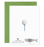E. Frances paper greeting card displaying a watercolor illustration of a white dimpled golf ball on a light blue tee, set against a plain white background with a vibrant green envelope partially visible and E. Frances branding featuring a gray whale barcode
