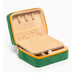Open green velvet jewelry travel case with beige interior compartments and necklace hooks