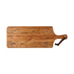 A paddle-style wooden charcuterie board features etched sections labeled 'STINKY CHEESE' 'OLIVES' and 'CRACKERS' with a brown leather handle strap