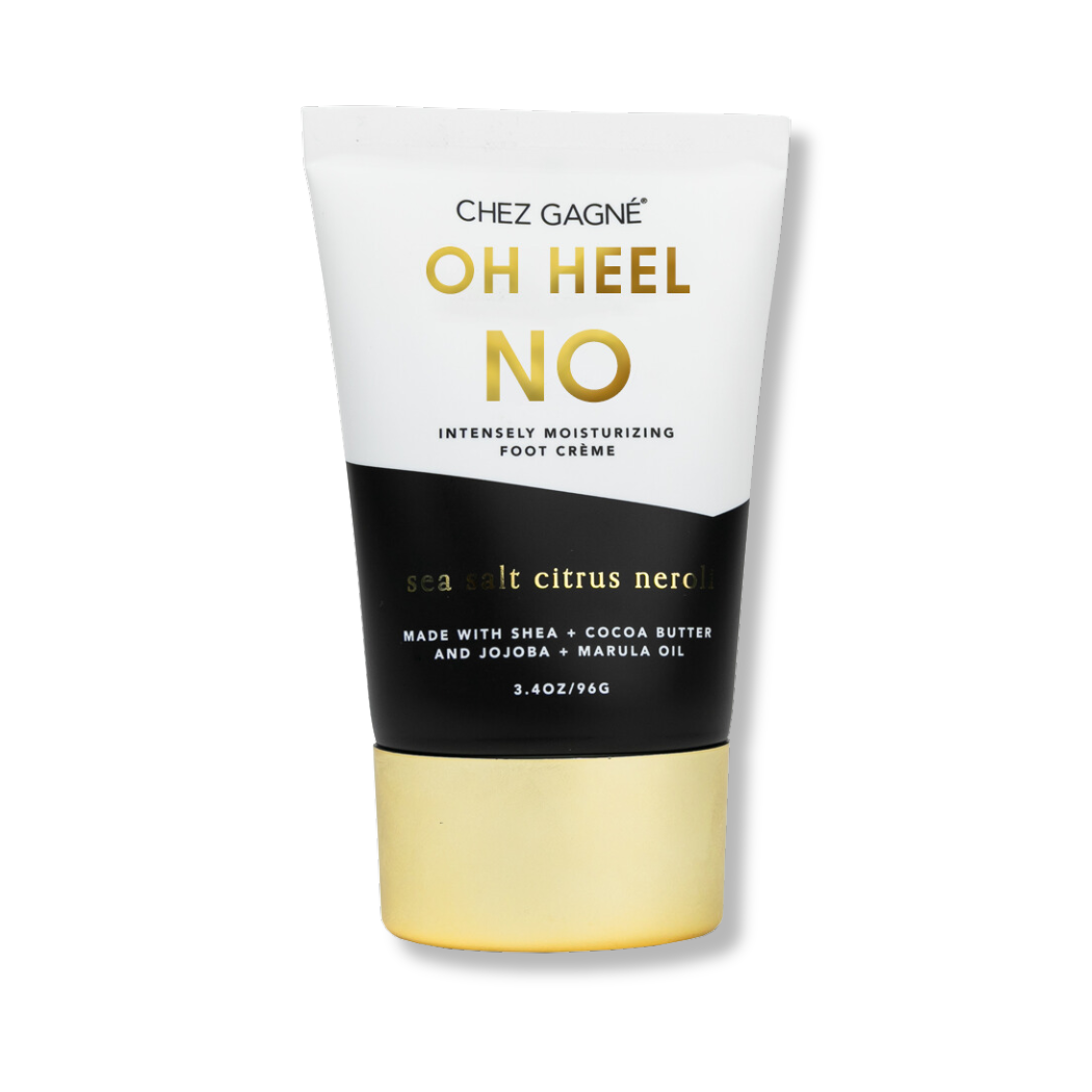 Product photography Chez Gagné OH HEEL NO Intensely Moisturizing Foot Crème tube in a striking white, black, and gold design, highlighting "Sea Salt Citrus Neroli" and ingredients like shea and cocoa butter on a white background