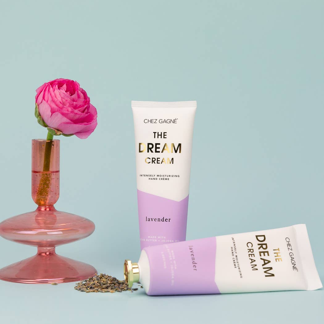 Two tubes of Chez Gagne The Dream Cream lavender hand creme with a pink flower in a glass vase and dried lavender