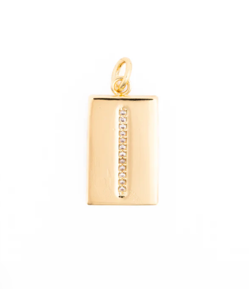 Gold jewelry pendant showcasing a rectangular charm centered on a white background with a vertical strip of pavé-set clear crystals and a polished yellow gold finish featuring a circular bail