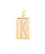 Gold jewelry charm featuring a rectangular pendant with a pave-set crystal letter K centered on a white background, showcasing its high-polish finish and small top jump ring