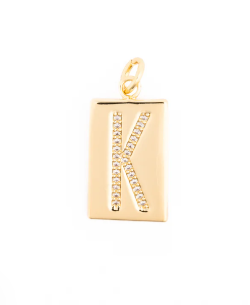 Gold jewelry charm featuring a rectangular pendant with a pave-set crystal letter K centered on a white background, showcasing its high-polish finish and small top jump ring