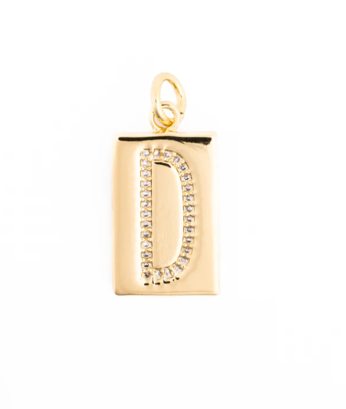 Gold jewelry pendant featuring a rectangular charm with a pavé-set letter D adorned with shimmering clear stones, a polished gold finish, and a circular top bail centered against a white background