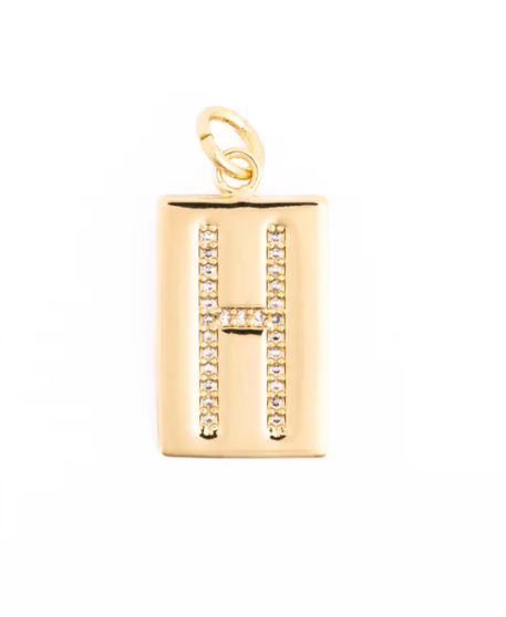 Gold rectangular pendant featuring a central pave-set letter H with shimmering white crystals on a polished metallic surface and a round top bail against a clean white background