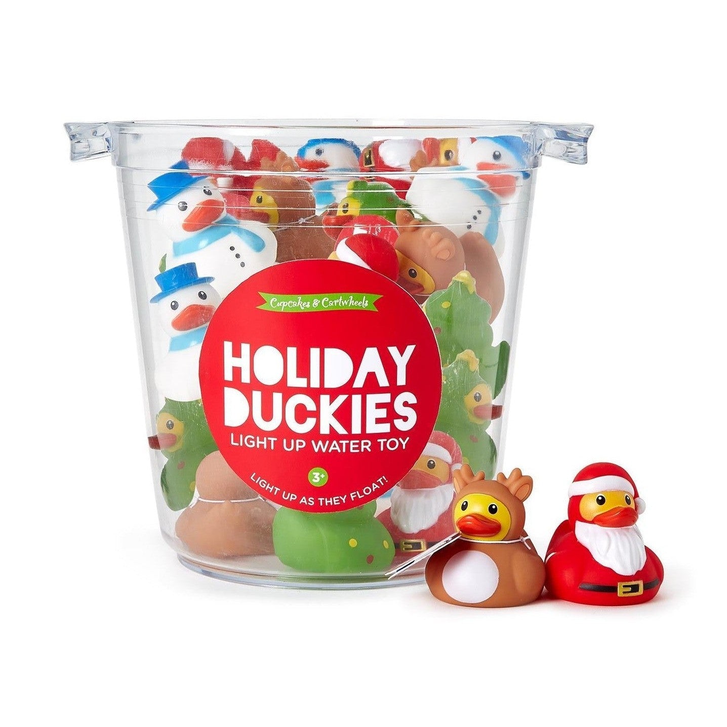 Product photography by Cupcakes & Cartwheels a clear plastic tub filled with assorted holiday rubber ducks on a white background featuring a red Holiday Duckies light up water toy label a brown reindeer duck and a red Santa duck sitting in front with snowman and Christmas tree ducks visible inside