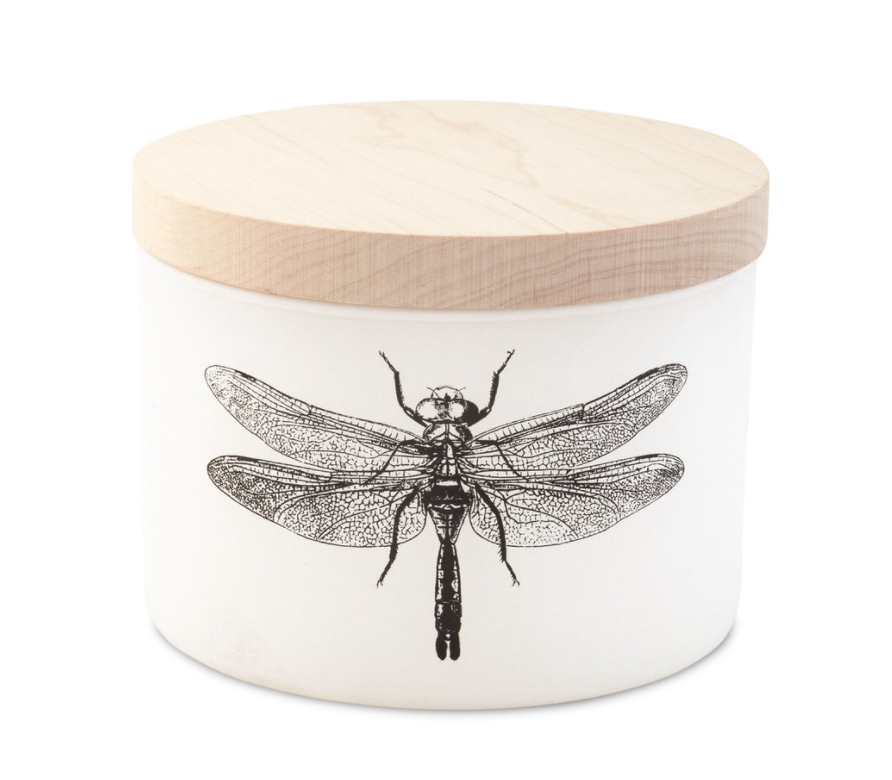 White ceramic candle jar with wooden lid and black dragonfly illustration