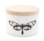 White cylindrical candle jar with a wooden lid and a black butterfly illustration