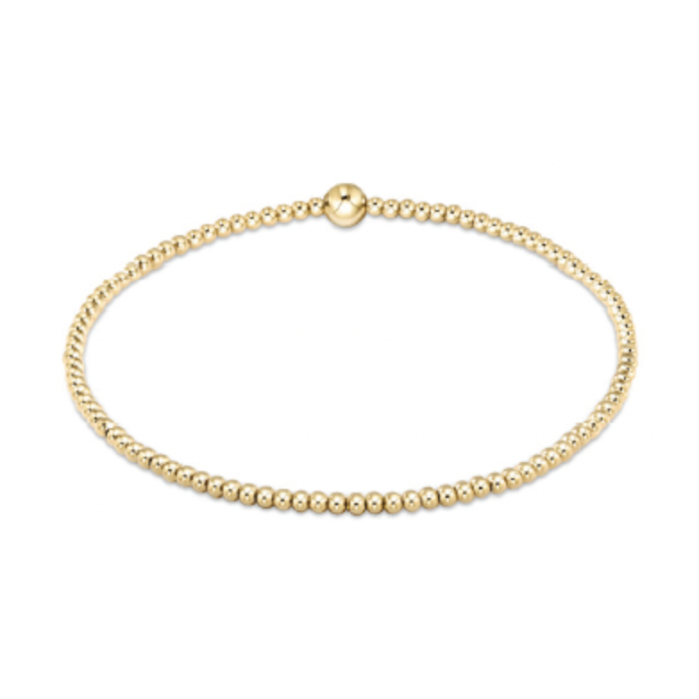 Gold beaded stretch bracelet with a single larger central bead