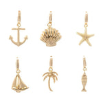 Gold charms presenting a collection of seaside motifs featuring a classic anchor, a ridged seashell, and a tropical palm tree