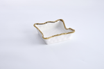 Ceramic square decorative dish on a white background featuring an irregular wavy rim and a metallic gold beaded edge with a glossy white finish