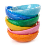 A stack of six vibrant marbled resin bowls featuring an ombre color progression from orange through pink, yellow, green, deep blue, and light blue against a clean white background