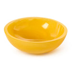 Photograph of a bright yellow glossy ceramic bowl with smooth curved edges on a white background