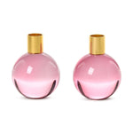 Two identical pink spherical glass decorative vases with shiny gold metal tops