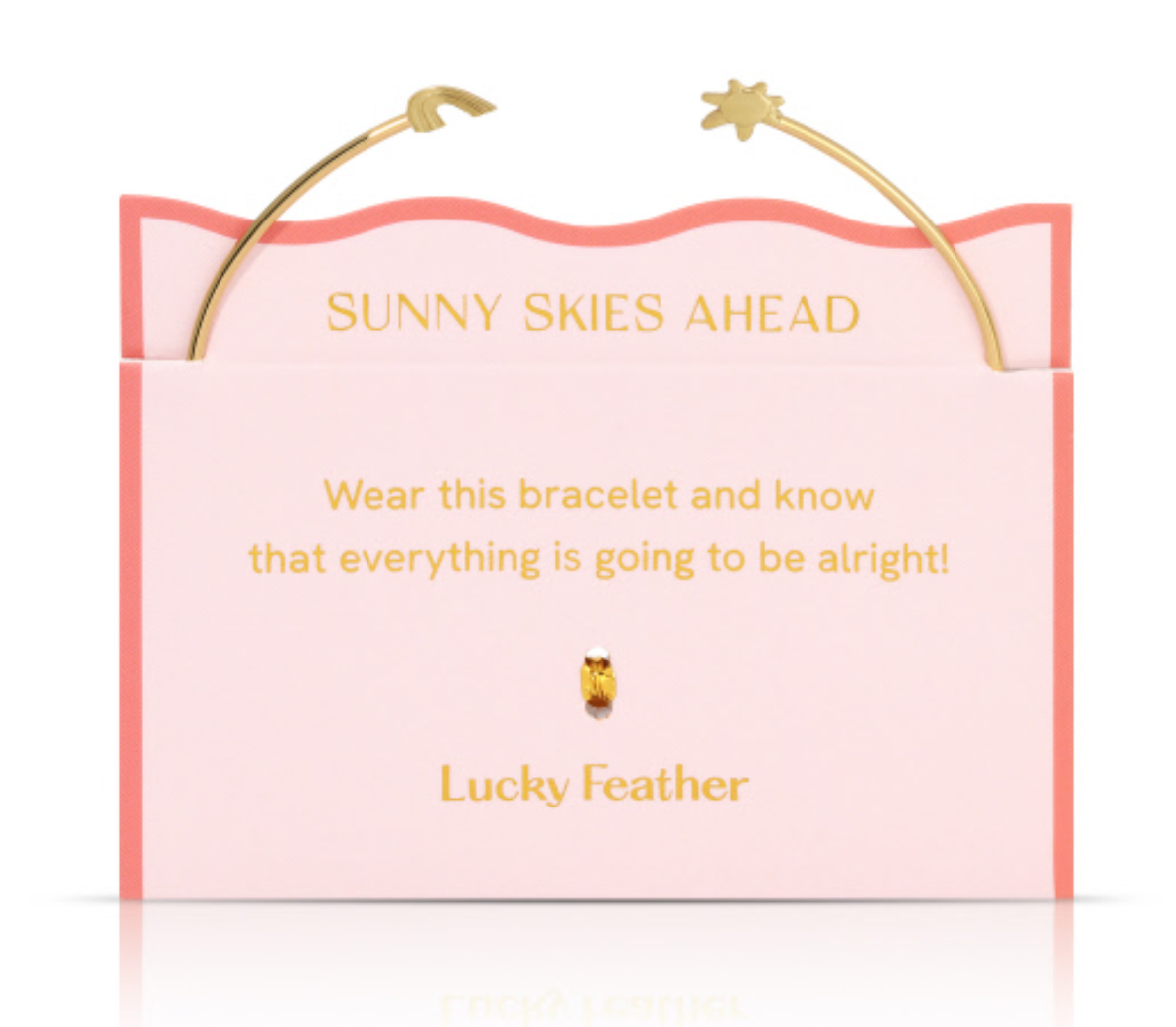 Gold bracelet by Lucky Feather, featuring wave and sun charms, presented on a pale pink card with a coral wavy border, gold text 'Sunny Skies Ahead', and a small golden feather charm