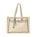 Beige canvas tote bag featuring a black outline illustration of a Hermès Birkin bag with its distinctive flap, buckle straps, padlock, and clochette detail
