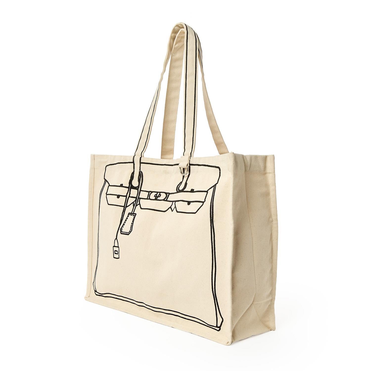 Cream-colored canvas tote bag with a black line drawing mimicking a classic Birkin-style handbag featuring its distinctive flap, buckle straps, and a hanging clochette key fob