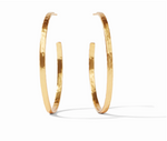 Pair of large gold hoop earrings with a hammered texture