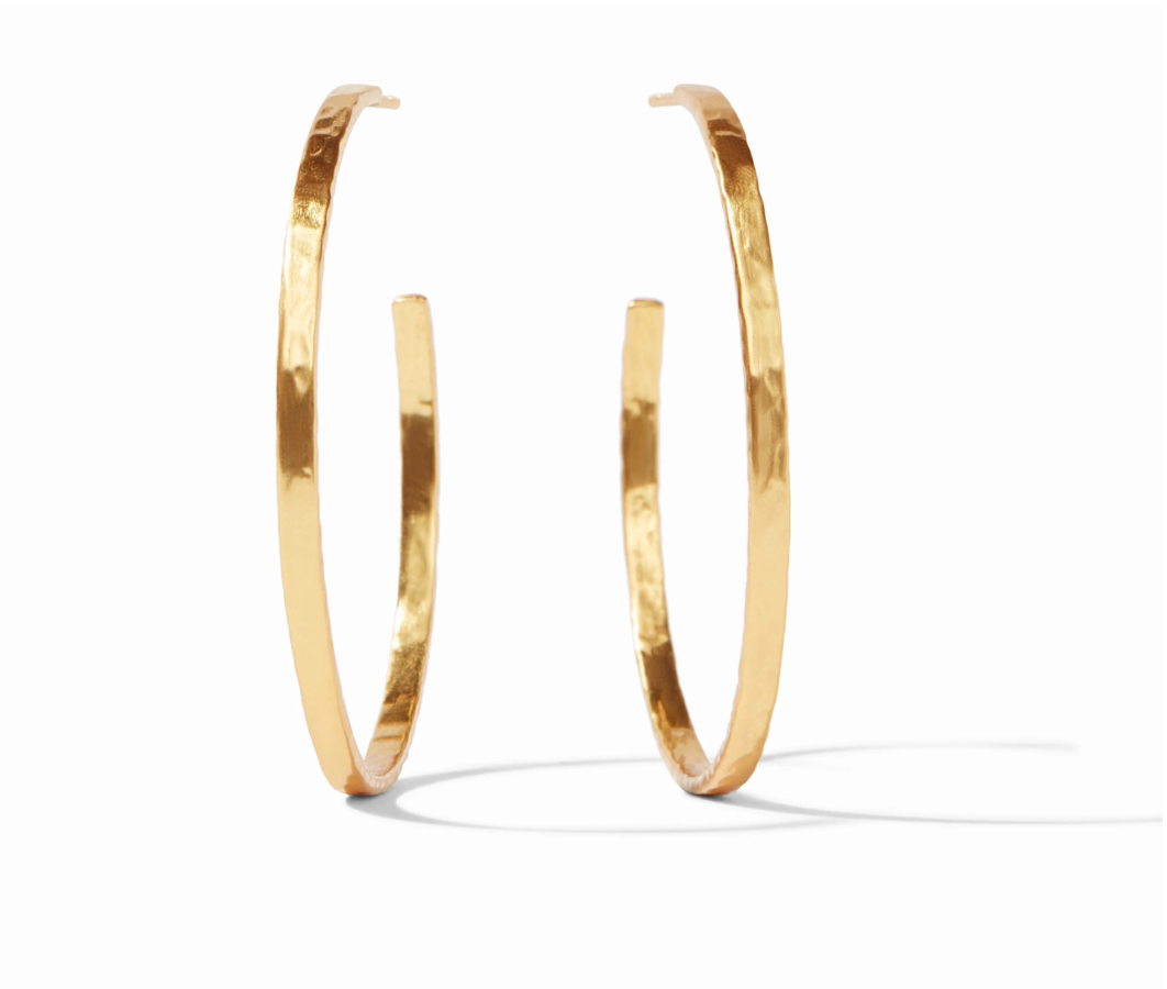 Pair of large gold hoop earrings with a hammered texture